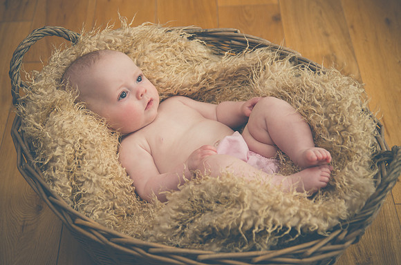 cute-baby-is-lying-inside-the-basket