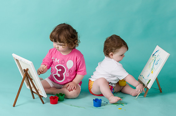 babies-painting-on-a-canvas-with-their-fingers