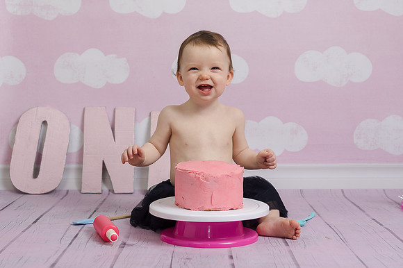 baby-girl-smiling-with-her-birthday-cake