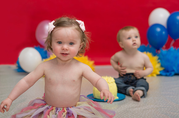 two-babies-with-red-background