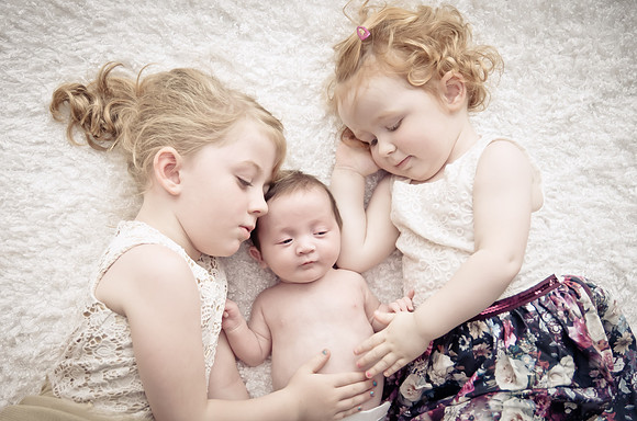 Tow-girls-with-their-baby-on-the-blanket