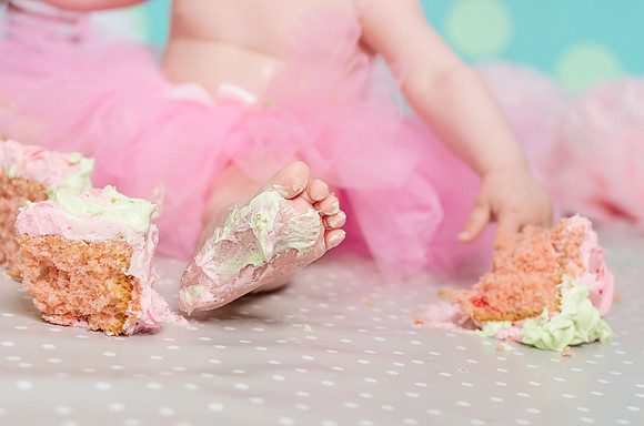 baby-playing-with-her-birthday-cake