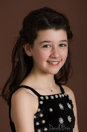 Girl-Smiling-with-Brown-Background