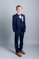 Communion-boy-smiling-with-his-hands-in-the-pockets