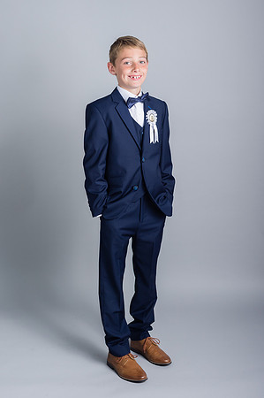 Communion-boy-smiling-with-his-hands-in-the-pockets