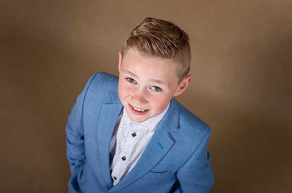 Boy-smiling-with-brown-background