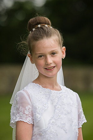 girl-smiling-in-her-communion-dress