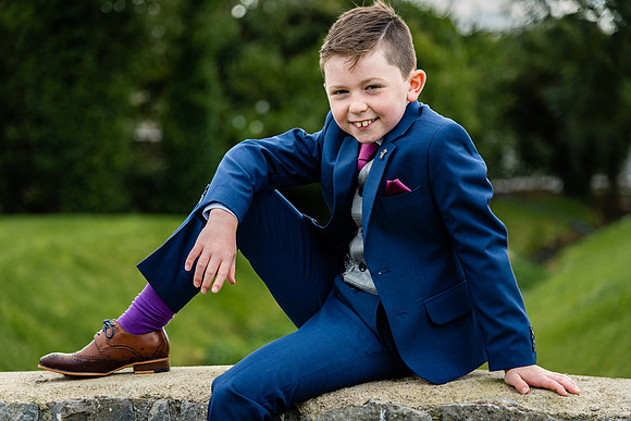 communion-boy-sitting-on-a-wall