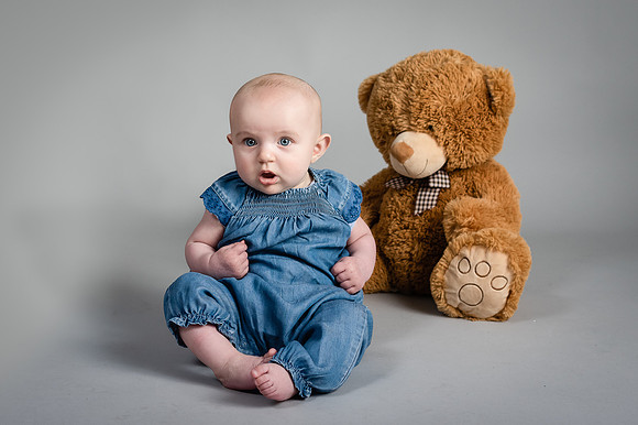 Baby-impressed-with-their-plush-in-background